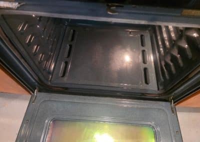 Spotless clean oven interior with a crystal-clear glass door ready for home cooking after a thorough scrubbing.